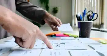 person writing on white paper